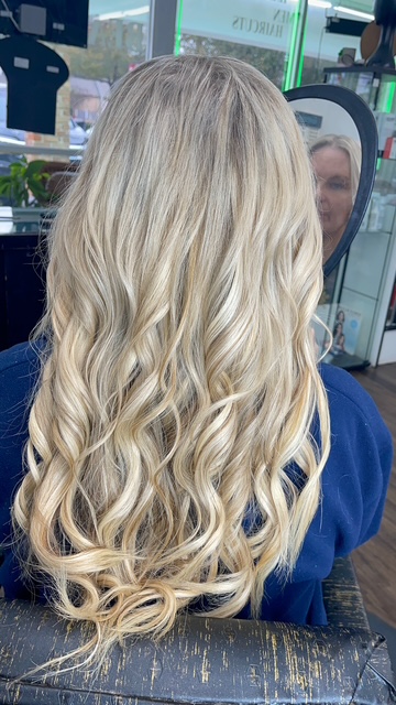 Long blonde balayage curls styled at The Hair Room By Janeth in Spring, TX